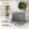 A grey storage box is shown in a modern interior setting with a plant and a circular inset image of a small table and chairs on a balcony. Produktbild-Vorschau