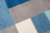 A close-up view of a rug with a geometric pattern. Náhled obrázku produktu