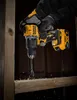 A person wearing gloves is using a DeWALT drill to drill into a wooden beam. Anteprima dell’immagine prodotto