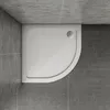 A top-down view of a white corner shower tray with a drain in the corner, set against a backdrop of grey tiles. Produktbild-Vorschau