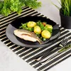 A plate of food with fish and potatoes on a placemat. Podgląd zdjęcia produktu