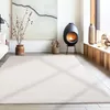 A modern living room with a fireplace, artwork, and a large rug. Produktbild-Vorschau