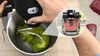 A person is using a kitchen robot to mix green dough. An inset shows the mixing action with red lines. Náhled obrázku produktu