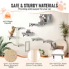 A wall-mounted cat tree with multiple platforms, a hammock, and a scratching post, shown with cats interacting with it. Text highlights safety and material features. Náhled obrázku produktu