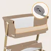 A close-up view of a baby bassinet with a rolled-up strap in a circular overlay. Náhľad obrázku produktu