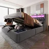 A bedroom with a large storage bed with its lift-up mechanism open, revealing stored items. The bed has LED lighting.