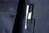 A close-up shot of a silver pen clipped into the pocket of a dark blue garment. Náhled obrázku produktu