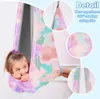 A young girl is sitting in a colorful sensory swing indoors. Produktbild-Vorschau