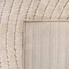 A close-up view of a beige rug, showing both the textured top surface with diagonal lines and the woven backing. Podgląd zdjęcia produktu