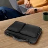 A person is using a laptop while a black laptop bag sits on a wooden table. Produktbild-Vorschau