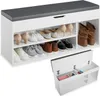A shoe bench with storage and a cushioned top, displaying various shoes on its shelves. Produktbild-Vorschau