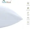 A close-up of a white pillow with various feature icons and text on the right side. Produktbild-Vorschau