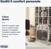 A personal heater is shown in a living room setting with a bookshelf in the background. Voir les images du produit