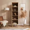 A living room scene with a bookshelf, chair, and floor lamp. Produktbild-Vorschau
