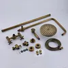 A collection of brass-colored shower fixture components laid out on a light gray surface. Náhled obrázku produktu