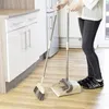 A person is sweeping the floor in a kitchen with a broom and dustpan. Náhľad obrázku produktu