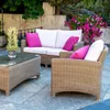 An outdoor patio set with a sofa, armchair, and coffee table, decorated with pink cushions and a potted plant. Náhled obrázku produktu