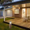 An outdoor patio area with a wooden deck, furniture, and a garden light. Podgląd zdjęcia produktu