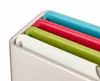 A close-up view of a set of four colorful cutting boards stored in a white holder. Podgląd zdjęcia produktu