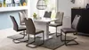 A dining room scene with a white table and chairs. Produktbild-Vorschau