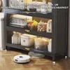 A kitchen cabinet with appliances and food items, with a robot vacuum cleaner on the floor. Anteprima dell’immagine prodotto