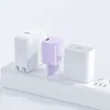 Three compact power adapters are plugged into a white power strip. Anteprima dell’immagine prodotto