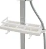 A close-up view of a white shower shelf attached to a chrome shower arm, with a flexible shower hose visible. Náhled obrázku produktu