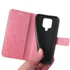 A hand holding a pink flip phone case open, revealing the black interior where a phone would be placed. Produktbild-Vorschau