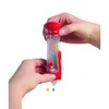 Hands holding a toy device with colorful rods inside, and small colored beads falling out. Náhled obrázku produktu