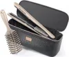 A hair styling set including a brush and a flat iron, presented in a black case. Anteprima dell’immagine prodotto