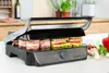 A close-up shot of a sandwich grill with sandwiches being prepared. Produktbild-Vorschau