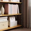 A bookshelf with books and storage boxes. Produktbild-Vorschau