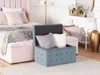 A bedroom scene with a bed, pillows, and storage ottomans. Náhled obrázku produktu