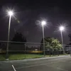 Outdoor tennis court at night, illuminated by floodlights. Náhľad obrázku produktu
