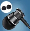 A close-up shot of black in-ear headphones with a blue background. Two black silicone ear tips are shown in a circular inset in the upper left corner. Voir les images du produit