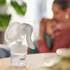 A close-up of a Philips AVENT hand breast pump with a mother and baby in the background. Produktbild-Vorschau