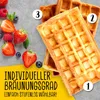 Waffles and berries on a gray surface with marketing text. Produktbild-Vorschau