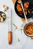 A grater and ingredients for a meal are laid out on a table. Anteprima dell’immagine prodotto