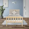 A bedroom scene with a wooden bed, plant, and a door. Náhľad obrázku produktu