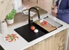 A kitchen scene with a sink, cutting board, and ingredients for a caprese salad. Produktbild-Vorschau