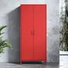 A red metal wardrobe standing against a concrete wall with a plant on the left and a blurred outdoor scene on the right. Anteprima dell’immagine prodotto