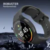 A smartwatch with a protective case is shown against a dark, rocky background with debris flying around. Produktbild-Vorschau