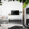 A modern living room with a TV stand, TV, and chair. Produktbild-Vorschau