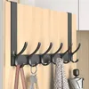 A black over-the-door hook rack with multiple hooks, mounted on a wooden door. Several items, including a bag, keys, a scarf, and a partially open umbrella, are hanging from the hooks. Produktbild-Vorschau