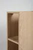 A close-up view of a light oak wood shelf unit, showing the grain and construction. Podgląd zdjęcia produktu