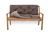 A brown tufted cushion and a gray rolled-up cushion are placed on a wooden bench. Produktbild-Vorschau