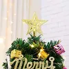 A close-up of the top of a small artificial Christmas tree, decorated with ornaments and lights, topped with a golden star. Produktbild-Vorschau