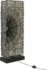 A tall, rectangular floor lamp with a black wire frame and a white fabric shade. The front of the shade has a decorative, fan-like pattern made of black material. Náhled obrázku produktu