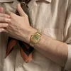 A close-up shot of a person's arm wearing a gold Casio watch, with a patterned scarf visible. Voir les images du produit