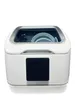 A white tabletop dishwasher with a transparent lid, showing plates and cutlery inside. Produktbild-Vorschau
